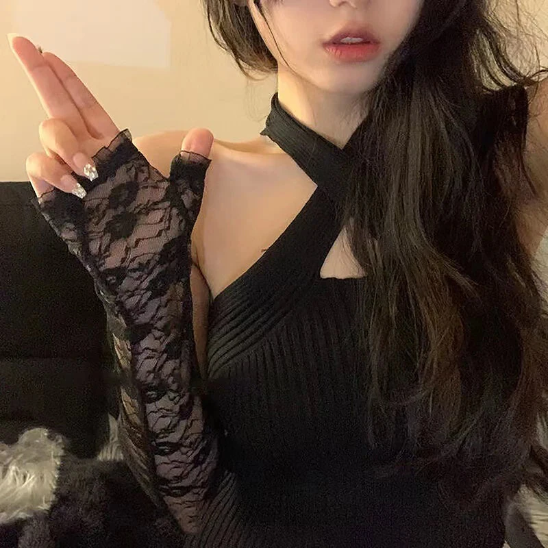 Black lace fingerless gloves worn with a black halter top
